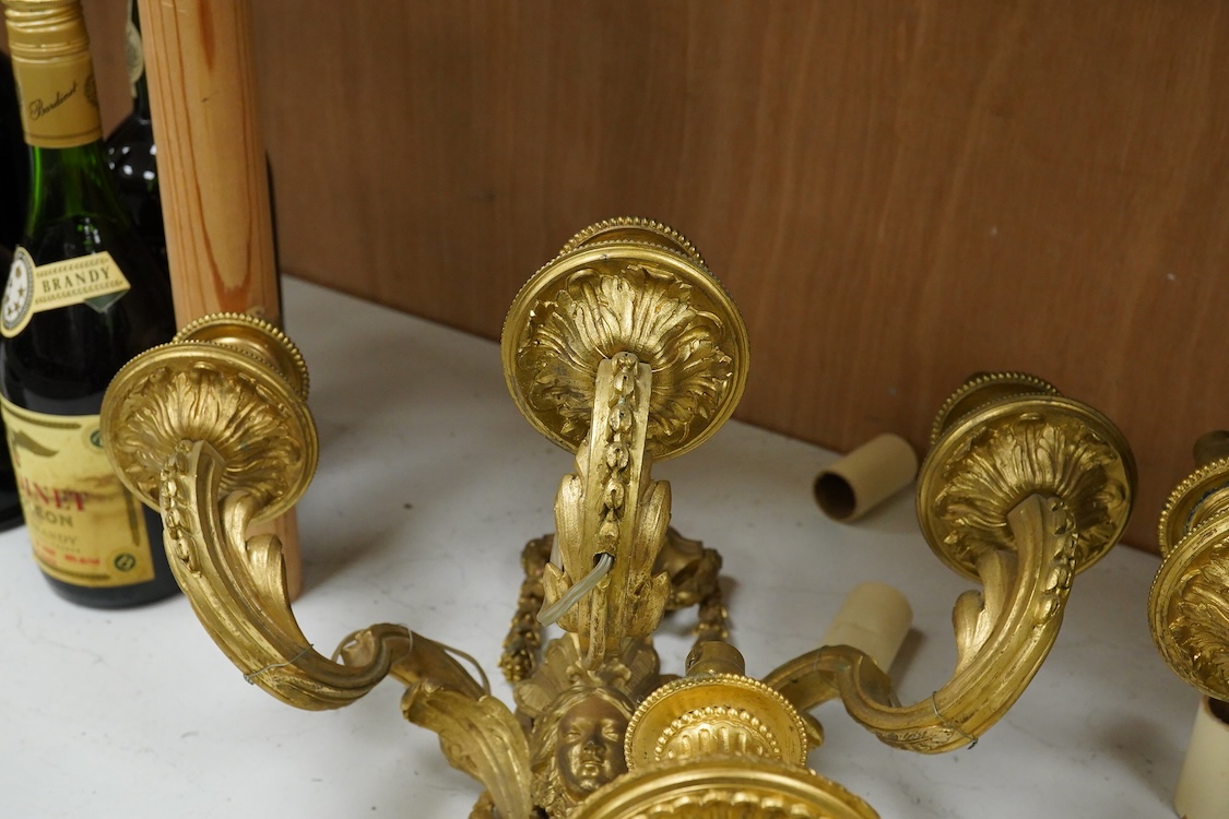 A pair of Adam style cast brass three branch wall sconces - 36cm high, with similar two branch sconce